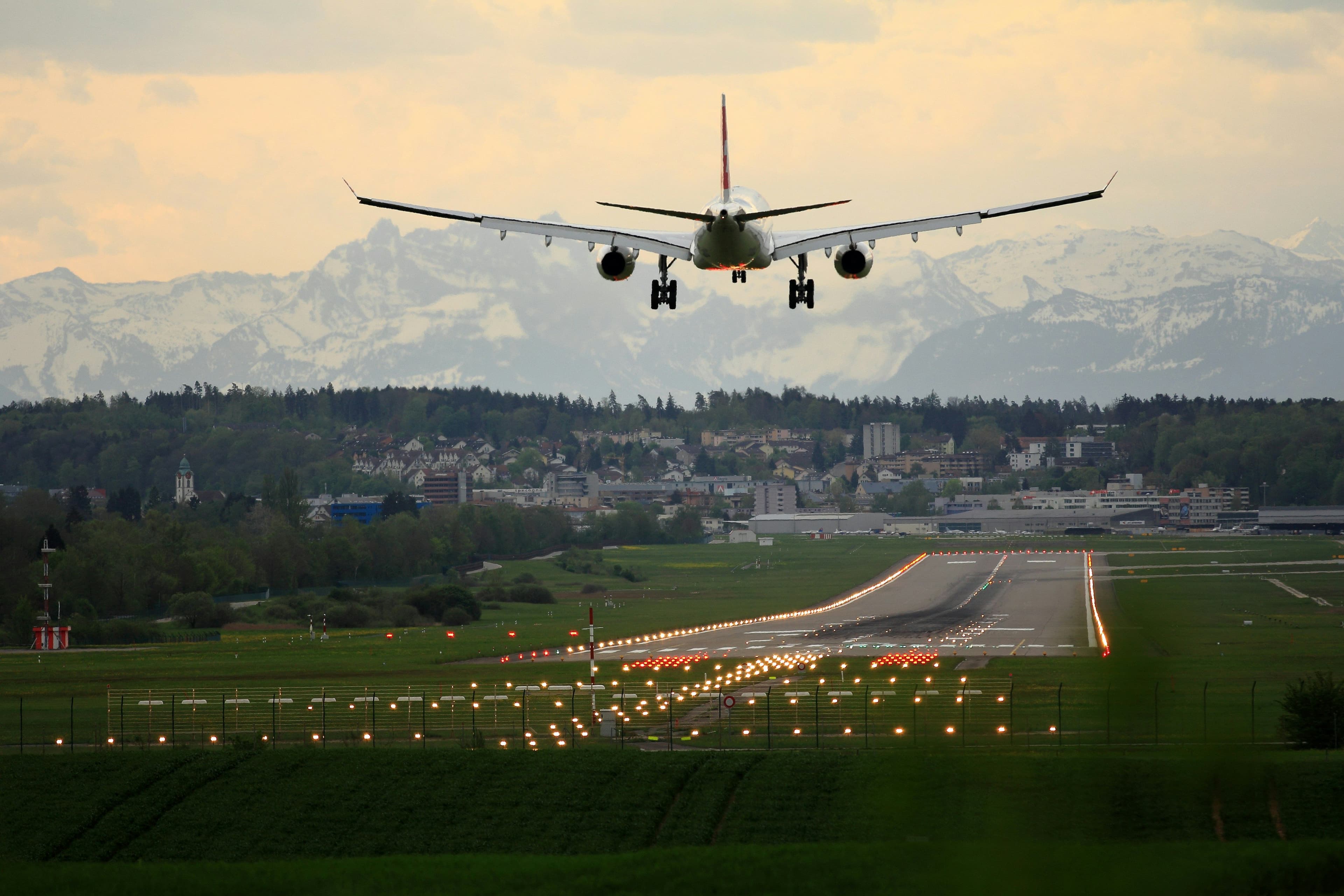 Airport apron with ground service vehicles and aircraft